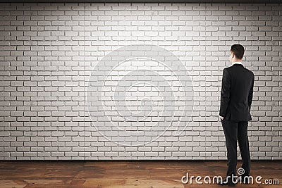 Man looking at empty brick wall Stock Photo