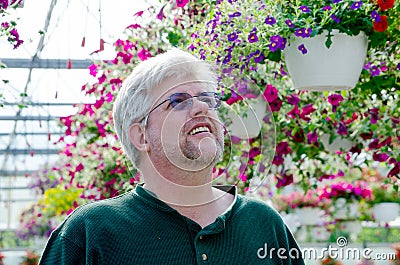 Man looking for flowering baskets Stock Photo