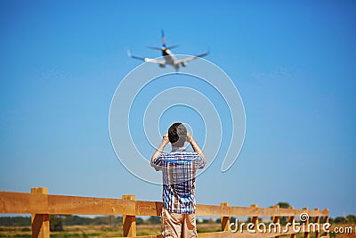 Man is looking at the glide path and landing plane Stock Photo