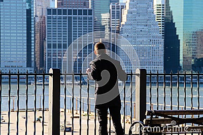 Man looking on Manhattan from Brooklyn Editorial Stock Photo