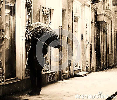 Man looking in a shop window in the snowy night Stock Photo