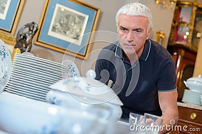 Man looking at table crockery Stock Photo
