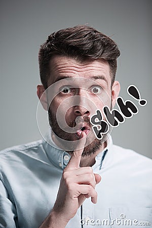 Man is looking wary. Over gray background Stock Photo