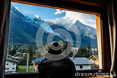 Man looking window Mont Blanc summit landscape view Chamonix Stock Photo