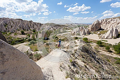 The man is looking at a wonderful landscape of Cappadocia in Turkey, near Goreme. Stock Photo