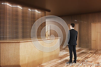 Man looking at wooden reception Stock Photo