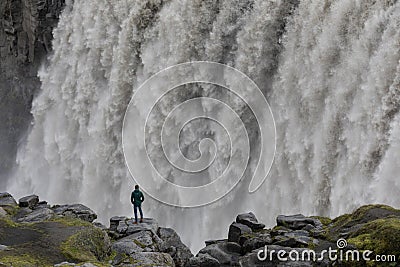 A man looks into the mighty torrents of the Dettifoss. Stock Photo