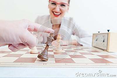 Man loosing game of chess against business woman Stock Photo