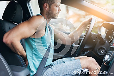 Man with back pain after a long drive in car Stock Photo