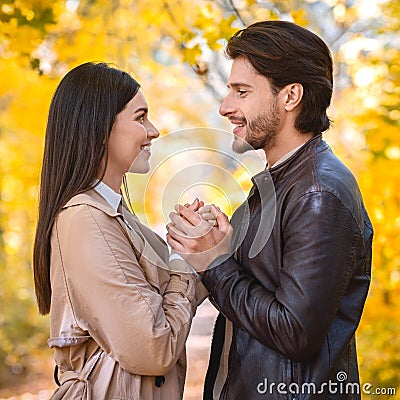 Man in love confessing his feelings to girlfriend, holding hands Stock Photo
