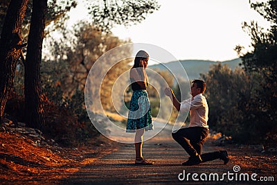 Man in love proposing a surprised,shocked woman to marry him.Proposal, engagement and wedding concept.Betrothal.Being affianced Stock Photo
