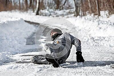 Man lying on the road, downfall and accident on winter season, black ice Stock Photo