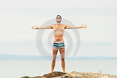 Man lying on the rock enjoying sunset Stock Photo