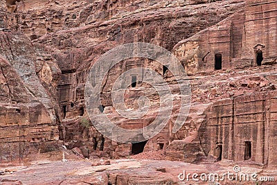 The man-made caves carved in red mountain in Petra - the capital of the Nabatean kingdom in Wadi Musa city in Jordan Editorial Stock Photo