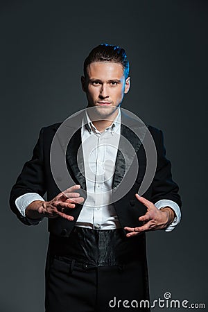 Man magician in balck tail coat conjuring tricks Stock Photo