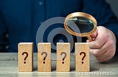 A man with a magnifying glass solves a mystery. Stock Photo