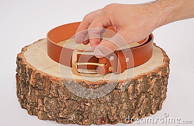 Man makes by hands leather belt with buckle. handmade hobby. young man resting by manufacture his designer belts. man with a screw Stock Photo