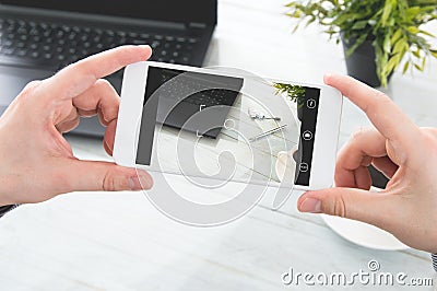 Man makes photos of desk Stock Photo