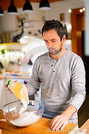 Young man making cookies at home. Stock Photo