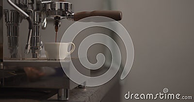 Man making espresso with single spout portafilter on coffee machine Stock Photo