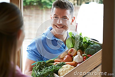 Man Making Home Delivery Of Organic Vegetable Box Stock Photo