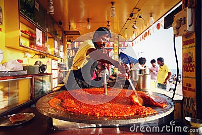 Man making Pao Bhaji in a giant pan at Juhu Beach, India Editorial Stock Photo