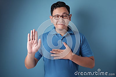 Man Making Pledge Gesture, Hand on Chest, Making Promise Stock Photo