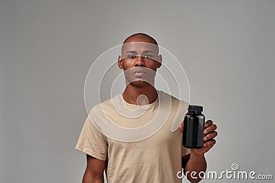 Man making a promotion of a black bottle Stock Photo