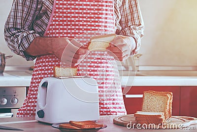 Man making toasts with toaster Stock Photo