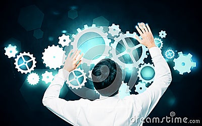 Man managing cogwheel mechanism Stock Photo