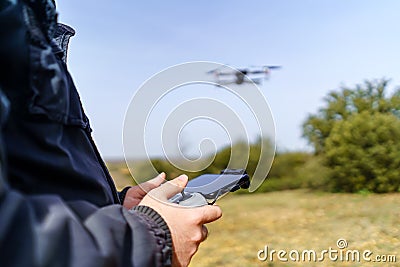 Man managing control over a drone flying in front of him Stock Photo