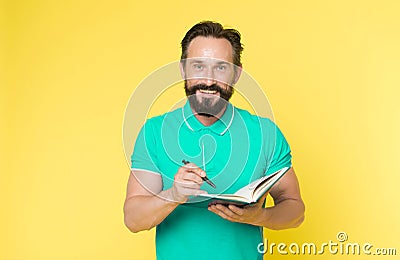 Man mature bearded guy writing notes to notepad. Check what is done. Daily schedule. Developing habits and set up Stock Photo