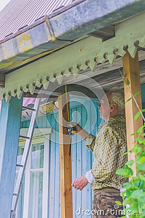 A man measures a tape measure the place of repair in his house Stock Photo