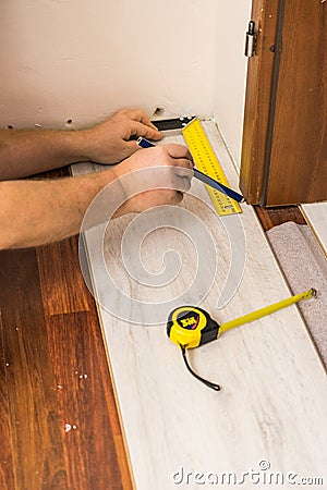 Man measuring floor panels Stock Photo