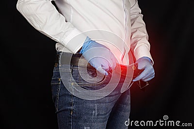 A man in medical gloves looks into his pants, close-up, prostatitis Stock Photo