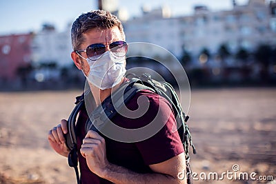 Man with medical mask outdoor.sunset. People, healthcare and medicine concept Stock Photo