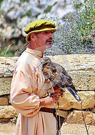 Man in Medieval Costume Holding a Hawk Bird Editorial Stock Photo