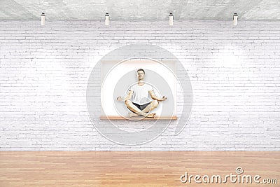 Man meditating on built-in-wall seating Stock Photo