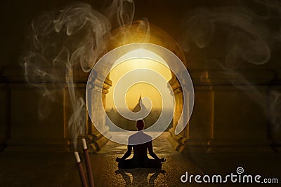 Man meditating between incense sticks Stock Photo