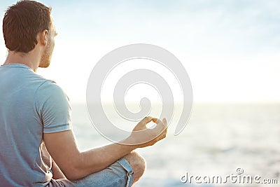 Man in meditation near the sea Stock Photo