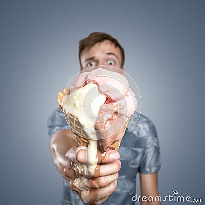 Man with a melting ice cream cone in his hand Stock Photo