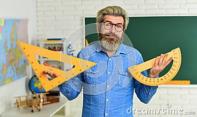 Man mentoring school projects. Math subject. Geometry and algebra. Theorem. Talented teacher. Science concept. Mature Stock Photo