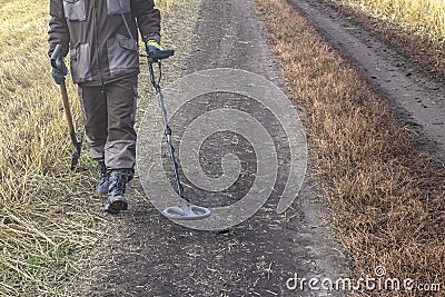 A man with a metal detector in search of a treasure Stock Photo