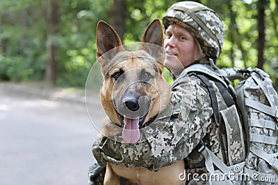 Man in military uniform with German shepherd dog Stock Photo