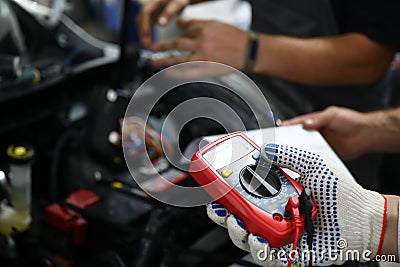 Man with modern amperemeter Stock Photo