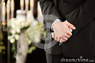 Man or mortician at funeral mourning Stock Photo