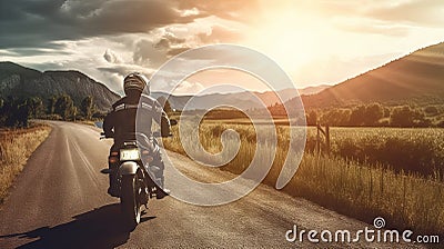 Man on motorcycle on a country road at sunset. Stock Photo