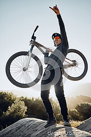 Man, mountain and bike celebrate, happy and excited after reaching summit in training. Cyclist, bicycle and rock in Stock Photo