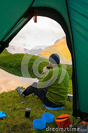 A man in mountain day summer. View from tent Stock Photo