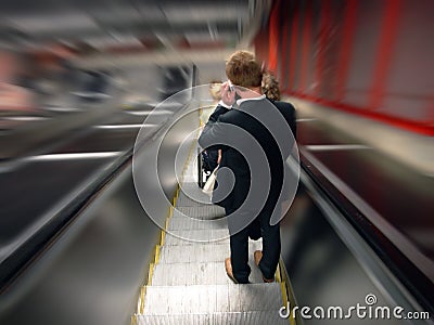Man in moving escalator Stock Photo